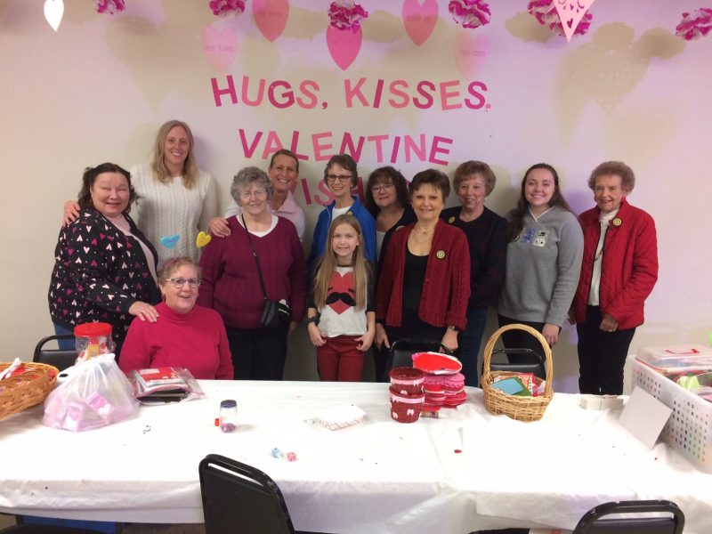 photo of adults and child gathered at Valentine's day party in 2019